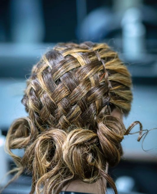 Close-up of an intricate woven braid hairstyle on a mannequin head. Close-up of an intricate woven braid hairstyle on a mannequin head.
